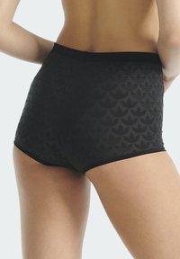 Czarne, biodrówki z wysokim stanem, ozdobione teksturowanym wzorem nakładających się na siebie kształtów liści, z gładkimi krawędziami i dopasowanym krojem w talii.