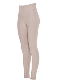 Leggings a vita alta in tessuto elastico di colore tan. Presentano un design seamless e dettagli di cucitura discreti lungo i lati.