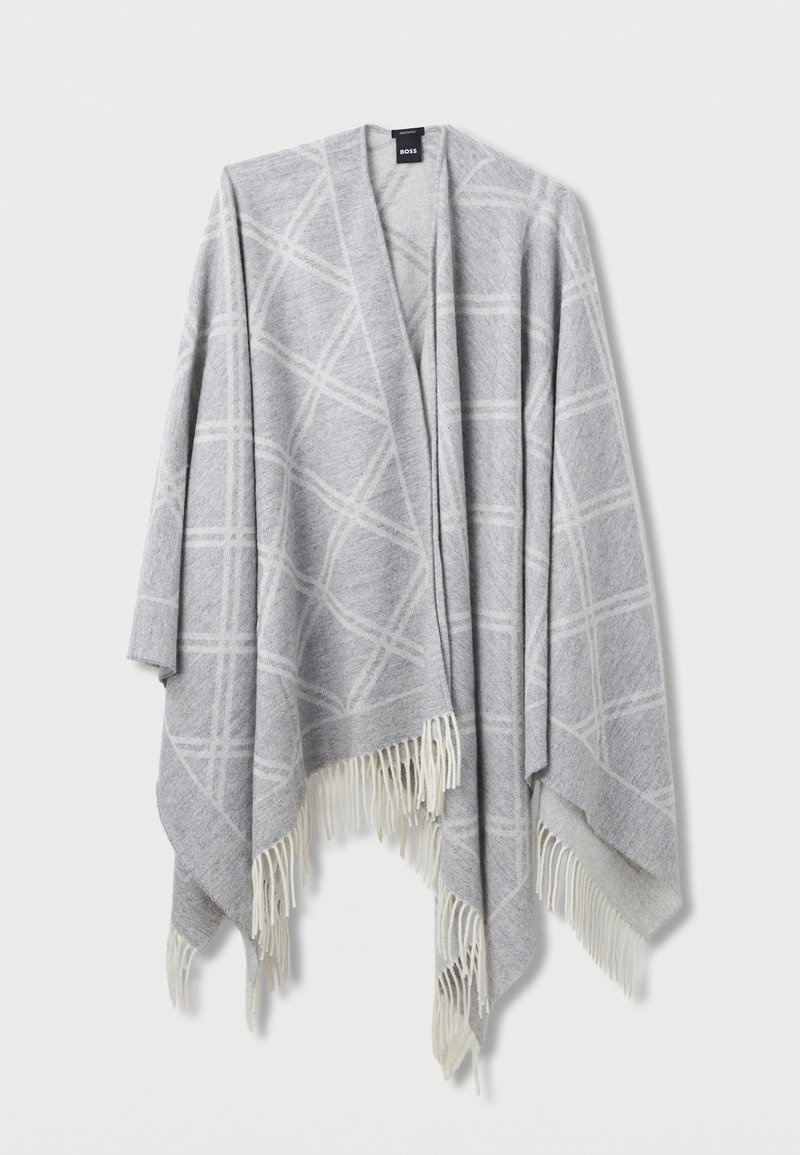Γκρι πόντσο με λευκό γεωμετρικό μοτίβο, τελειωμένο με κρόσσια στις άκρες. Κατασκευασμένο από μαλακό υλικό, διαθέτει ανοιχτό μπροστινό σχέδιο.