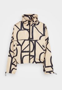 Giacca beige tagliata con motivi astratti neri, colletto alto, chiusura con zip frontale e polsini elasticizzati con cordini. Materiale liscio e leggero.