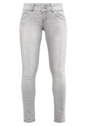 Light gray skinny jeans made from denim, featuring a smooth texture, two-button closure, and front pockets with curved seams.