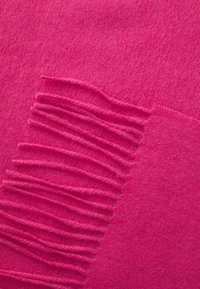 Bright pink wool scarf featuring soft texture, subtle gradient; one edge with evenly spaced fringes, enhancing visual interest.