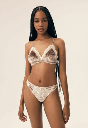 Velvet bralette and matching lace-trimmed bikini in soft beige, featuring floral patterns and thin adjustable straps.