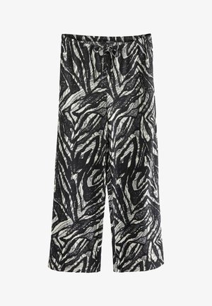 Mustavalkoiset leveälahkeiset housut, joissa on seeprahihenkinen kuosi, valmistettu teksturoidusta kankaasta, elastisella vyötärönauhalla ja nyörillä.