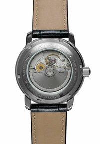 Stainless steel watch case with transparent back, featuring a Miyota movement. Black leather strap with beige underside, marked water-resistant.
