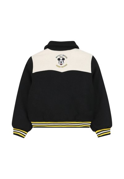 Giacca nera con una parte superiore bianca, dotata di un design ricamato di Topolino. Orlo a costine giallo e bianco e polsini a costine.