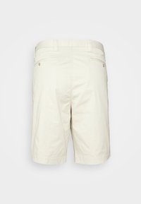 Pantaloni corti beige realizzati in morbido cotone, con un design semplice, tasche posteriori e dettagli di cucitura discreti.