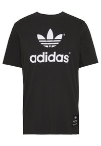 Černé bavlněné tričko s bílým logem Adidas a designem trifolium. Krátké rukávy a rovný střih, s etiketou na dolním levém boku.