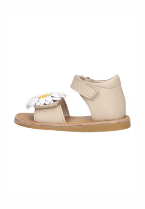 Beige toddler sandal with open toe, ankle strap, and white daisy decoration on front strap.