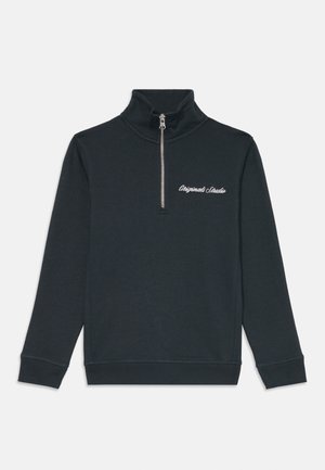 Dark gray zip-up sweatshirt with a high collar, featuring long sleeves and the text "Originals Studio" in white embroidered detail.