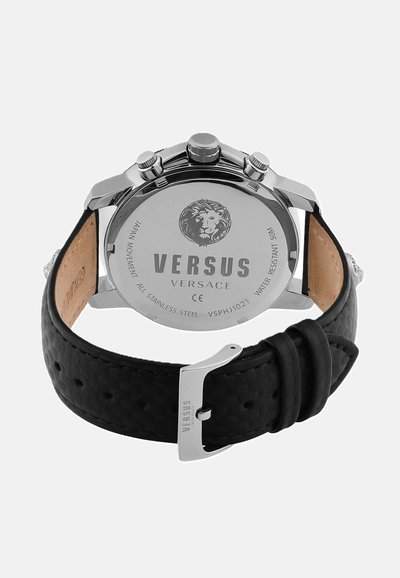Vue arrière d'une montre-bracelet Versus Versace avec un boîtier en acier inoxydable, un bracelet en cuir noir texturé et un logo de lion gravé au dos.