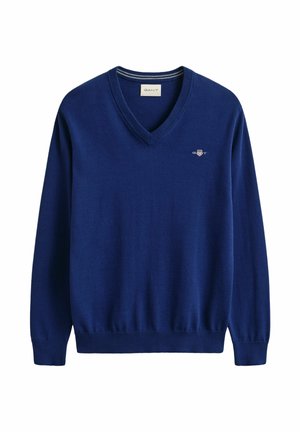 Pull V bleu marine à col en V avec manches longues, poignets et ourlet côtelés, et petit logo GANT sur la poitrine gauche.
