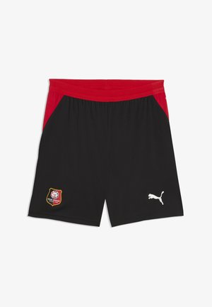 Pantalones cortos deportivos negros con cintura y laterales rojos, escudo del Stade Rennais FC en la pierna izquierda, logo blanco de Puma en la pierna derecha, sin personas presentes.