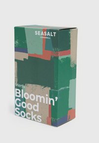 Vihreä laatikko, jossa on abstrakteja kuvioita punaisena, sinisenä ja beigeenä. Teksti kuuluu "Miesten Bloomin' Hyvät Sukat" ja brändin nimi on "Seasalt Cornwall."
