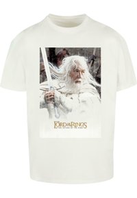 Witte katoenen t-shirt met een voorzijde afbeelding van een personage met lang haar en een baard, die een zwaard vasthoudt. De tekst zegt: "The Lord of the Rings: The Return of the King."