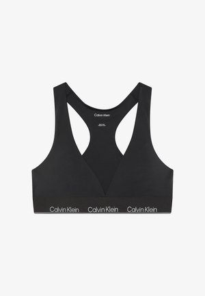 Czarny stanik sportowy z dekoltem w kształcie litery V, szerokimi ramiączkami i elastycznym pasem z logo "Calvin Klein". Gładka tekstura, prosty i nowoczesny styl.