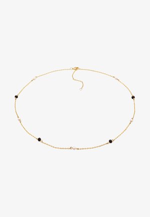 Goldkette mit schwarzen und weißen Perlen, die ein zartes Design aufweist und mit einem Karabinerverschluss für eine verstellbare Passform ausgestattet ist.