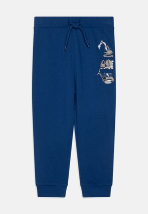 Pantalon pour enfant bleu foncé avec taille élastique et cordon, avec de petites illustrations de véhicules de chantier sur la cuisse droite.