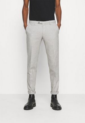 Light gray trousers made of woven fabric, slim fit, featuring front pockets, cuffed hems, and a single button closure. Paired with black boots.