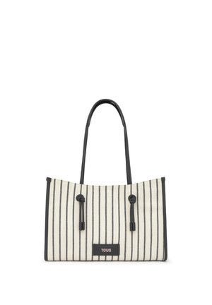 Prostokątna torebka w pionowe białe i czarne paski, z czarnymi uchwytami i etykietą "TOUS" z przodu.