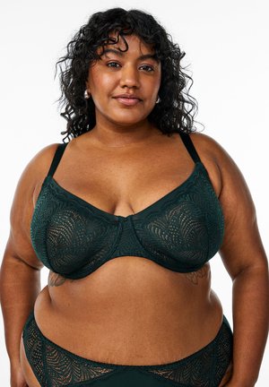 Soutien-gorge en dentelle vert foncé avec armatures, motifs de feuilles complexes, bretelles réglables et tissu lisse, conçu pour un ajustement soutien.