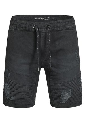 Shorts en denim noir avec une taille à cordon de serrage, présentant des détails côtelés et des patches déchirés sur l'avant. Longueur jusqu'au milieu de la cuisse.