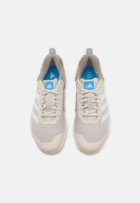 Light gray athletic shoes featuring a mesh upper, three white stripes, a blue insole, green accents, and a textured rubber sole.