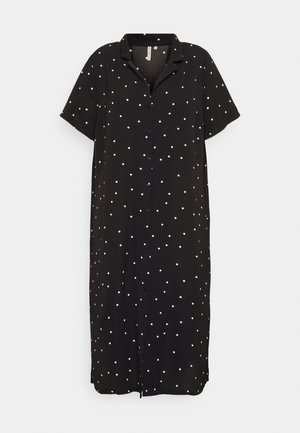 Black midi shirt dress with white polka dots, short sleeves, collar, and front button closure.