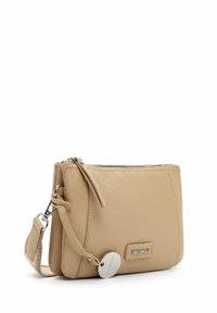 Beige leather crossbody bag with a textured finish, zip closure, and an adjustable strap. Features a metal logo plate and keychain detail.