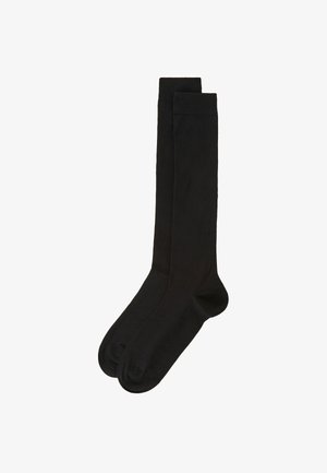 Zwarte knielange sokken van een glad, rekbaar materiaal met een ribbelboord aan de bovenkant. Naadloos te ontwerp voor comfort.