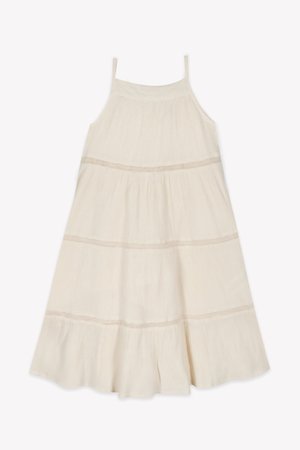 Light ivory sundress with thin straps, tiered design, textured fabric, and subtle horizontal stitching details. Flared hemline.