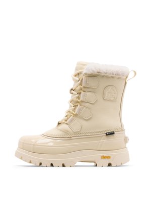 Botte d'hiver beige avec semelle en caoutchouc, devant à lacets, doublure en polaire et semelle Vibram, conçue pour les conditions froides et humides.