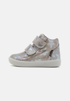 Velcro strap sneaker in metallic silver and light gray with star pattern, rubber outsole, rounded toe, and textured fabric finish.