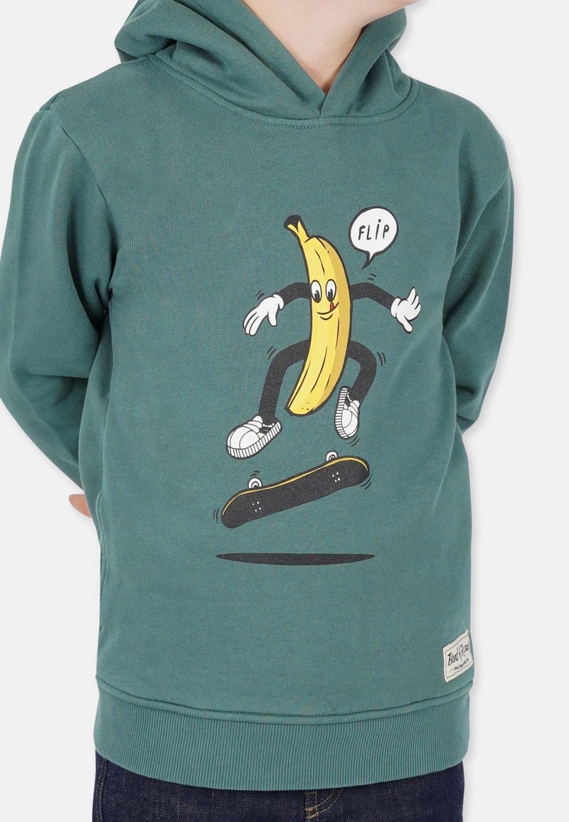 Child wearing green hoodie with cartoon banana character skateboarding and saying "FLIP" on front.