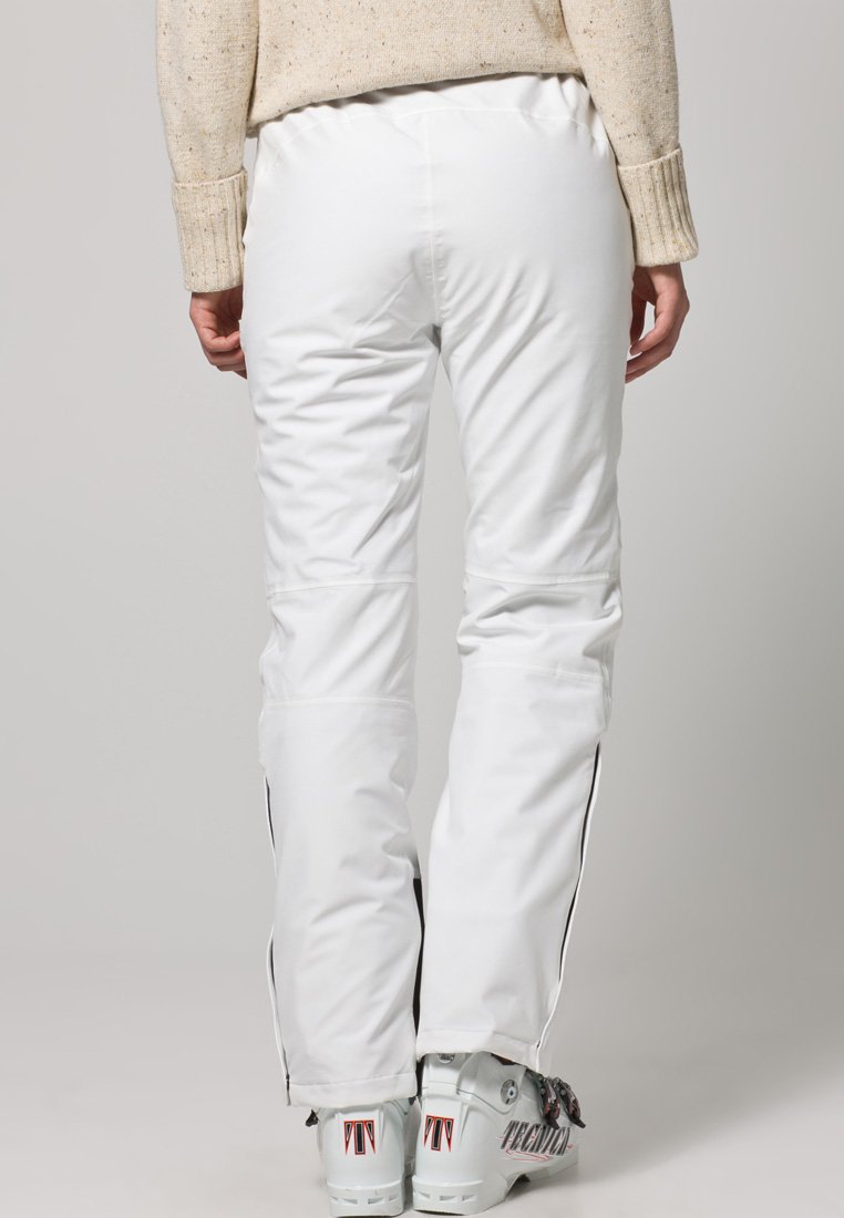 Witte skibroek met een gladde textuur, ritssluiting aan de zijkanten en zwarte zijstrepen, gecombineerd met lichtblauwe skisk schoenen met merkbedrukkingen.