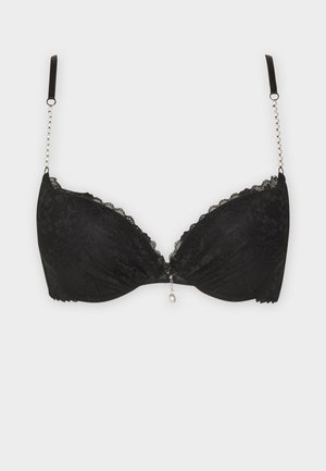 Zwarte kanten beha met padded cups, gegolfde randen en een decoratieve parel aan de voorkant. Verstelbare banden met kraalaccenten aan de zijkanten.