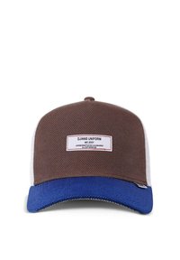 Brown and blue cap with a mesh design, featuring a structured brim, a textured fabric, and a label stating “DJINNS UNIFORM est. 2001.”