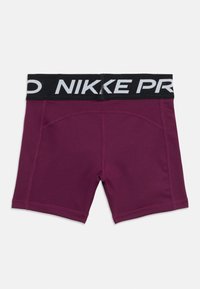 Bordo atletske kratke hlače s crnim pojasom na kojem je bijeli natpis "NIKE PRO". Glatka tekstura, uski dizajn s ravnim šavovima i bez džepova.