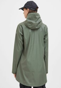 Water-resistant green rain jacket with a hood, long sleeves, and a straight cut. Back view shows smooth texture and minimal design details.