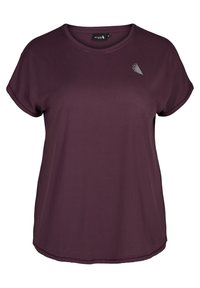 T-shirt z krótkim rękawem i okrągłym dekoltem w intensywnym fioletowym kolorze. Wykonany z miękkiego materiału, z małym graficznym akcentem na klatce piersiowej. Luźny krój.