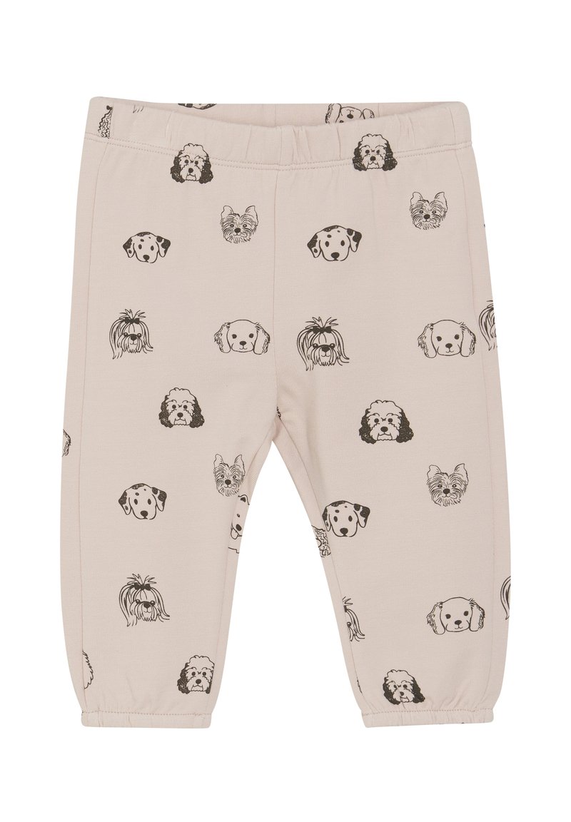 Jasno beżowe legginsy z powtarzającym się wzorem czarnych głów psów. Wykonane z miękkiego materiału, z elastycznym pasem w talii i zwężającymi się nogawkami.
