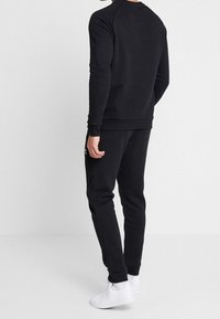 adidas Originals Träningsbyxor - black