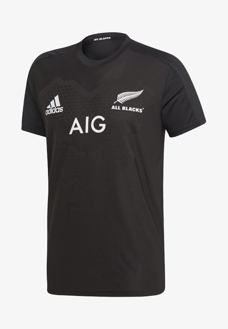 T-shirt sportivo nero realizzato in tessuto leggero. Caratterizzato dal logo Adidas, dal branding "AIG" e dal testo "ALL BLACKS". Collo a giro, maniche corte.