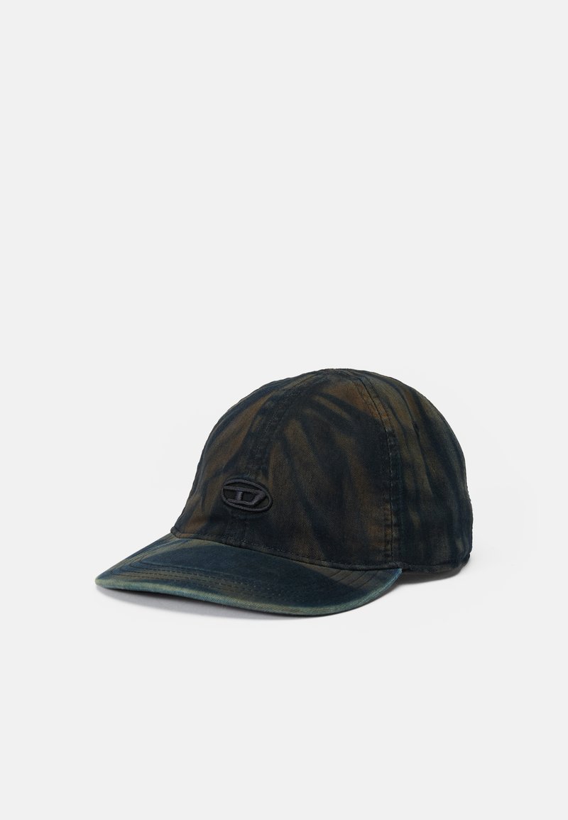 Cap made of textured, dark fabric with a tie-dye pattern in shades of green and brown. Features a curved brim and a black logo patch on the front.