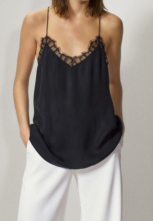 Black satin camisole with a V-neckline, featuring delicate black lace trim along the edges and adjustable spaghetti straps.