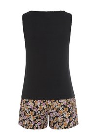 Black sleeveless top paired with floral shorts. The shorts feature a black background with orange and purple flowers. Textured fabric.