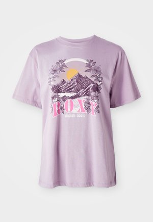 Lilac T-shirt made of cotton, featuring a graphic of mountains, sun, and foliage. The brand name "ROXY" is prominently displayed in pink.