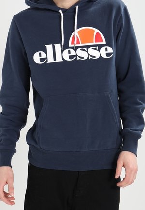 Sudadera azul marino con un bolsillo frontal, cordones blancos y un gran logotipo de Ellesse que presenta un diseño de semicírculo en naranja y blanco.