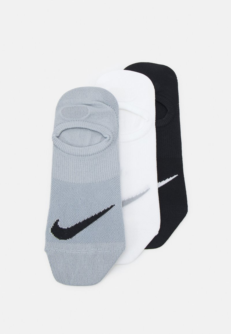 Tre par lave sokker i grå, hvit og svart materiale. Hver av dem har et Nike-logo på toppen med en glatt tekstur.