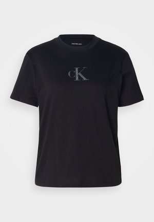 Czarny bawełniany t-shirt z klasycznym okrągłym dekoltem, krótkimi rękawami oraz srebrnym logo "cK" na środku przodu. Gładka faktura.